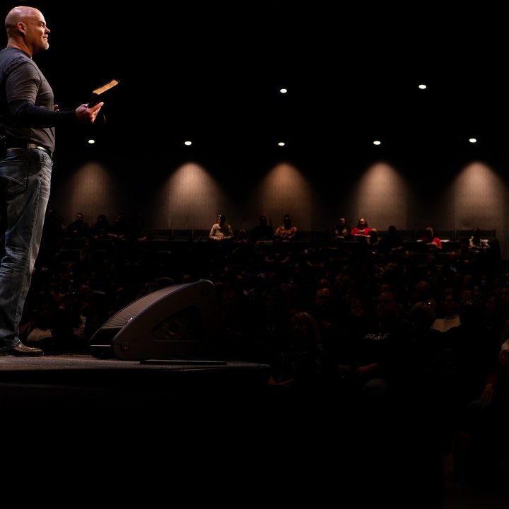 preacher on stage delivering sermon