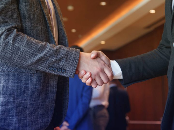 two business men shaking hands, partnership